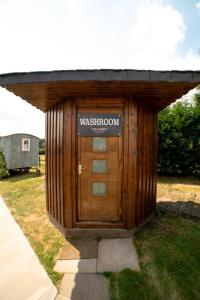 a wooden building with a sign on the door at Old Hall House, NEC in Meriden