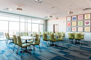 a conference room with tables and chairs and windows at Holiday Inn Express & Suites Madison by IHG in Madison +60 photos