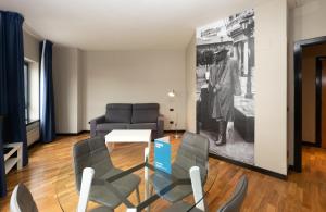 a living room filled with furniture and a painting at Aparthotel Campus in Oviedo