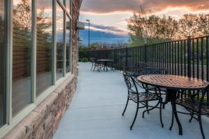 a patio with tables and chairs on a balcony at Holiday Inn Hotel & Suites Grand Junction-Airport by IHG in Grand Junction