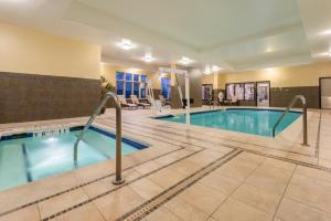 a pool in a hotel room with a hotel at Holiday Inn Hotel & Suites Grand Junction-Airport by IHG in Grand Junction