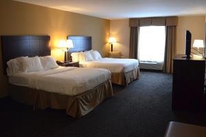 a hotel room with two beds and a television at Holiday Inn Express & Suites Sidney by IHG in Sidney +9 photos