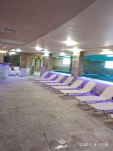 a row of white chairs in a large room at Hotel Caesars Palace in Sunny Beach