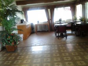 a dining room with a table and chairs and windows at Budget Inn in Tulare