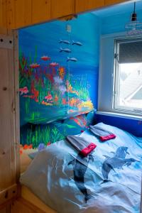a bed in a room with an aquarium painted on the wall at Nieuw: Kom in de Bedstee Uniek! in Winterswijk