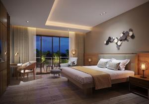 1 dormitorio con 1 cama, mesa y sillas en Nouveau Resort en Mambajao