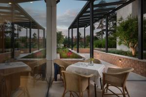 a restaurant with tables and chairs and windows at Hotel Milan in Pula