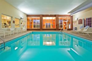 a swimming pool with blue water in a building at Holiday Inn Express Hotel & Suites Manchester Conference Center, an IHG Hotel in Manchester