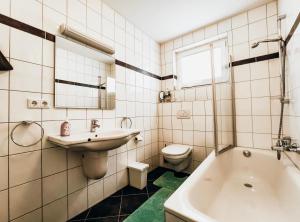 a white bathroom with a sink and a toilet at Xenos Apartments in Willingen