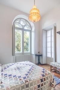 a bedroom with a bed and a large window at Villa Niobe - Exclusive Lakefront Apartment With Private Beach in Stresa