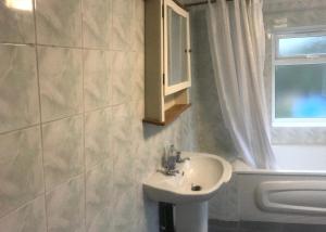 a bathroom with a sink and a mirror at New Cross House in Wolverhampton