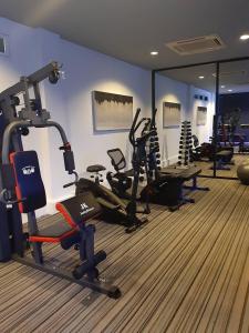 a gym with several tread machines in a room at Cher Resort SHA Plus Certified in Cha Am