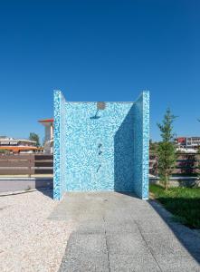 a blue brick wall with a face on it at Astra Sarti Luxury Suites in Sarti
