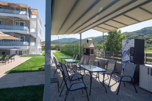 a patio with a table and chairs and a building at Astra Sarti Luxury Suites in Sarti