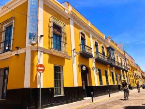 a yellow building on the side of a street at San Gil in Seville