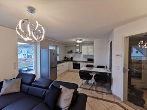 a living room with a couch and a kitchen at Luxuriöses Wellnes Apartment in Bad Essen