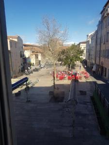 a view from a window of a street with a playground at appartement renové , quartier historique du panier , centre-ville in Marseille
