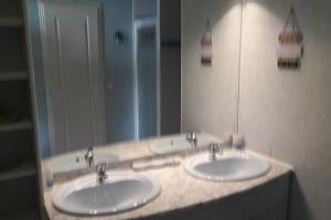 La salle de bains est pourvue de 2 lavabos et d'un grand miroir. dans l'établissement Cap d'Agde Naturist Villa Port Nature, au Cap d'Agde