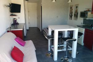 a hotel room with a bed and a desk and a table at Cap d'Agde Naturist Héliopolis K 106 in Cap d'Agde