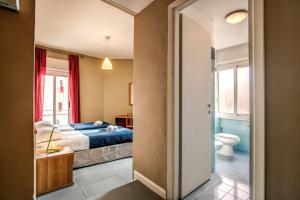 a bedroom with a bed and a bathroom at City Guest House in Rome