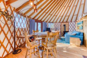 a room with a table and chairs and a couch at Yurt on the Bay in Bay City