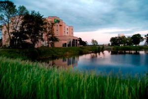 a building next to a river with a building at Holiday Inn Express Hotel & Suites Mankato East, an IHG Hotel in Mankato
