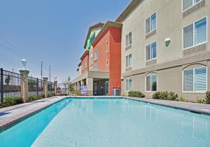 a swimming pool in front of a building at Holiday Inn Express Hotel & Suites Modesto-Salida, an IHG Hotel in Modesto