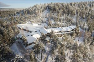 an aerial view of a house in the snow at Lapland Hotels Bear´s Lodge in Sinettä
