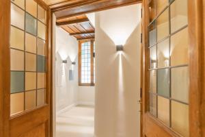 a hallway with a door and glass wall at Campo de' Fiori 34 in Rome