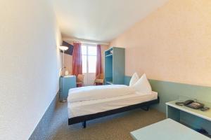 Postel nebo postele na pokoji v ubytování Hotel City am Bahnhof