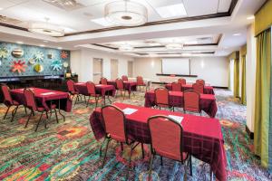 a conference room with red tables and chairs and a screen at Holiday Inn Express & Suites Eureka by IHG in Eureka +35 photos
