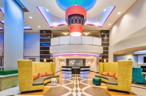 a lobby with yellow chairs and a red chandelier at Holiday Inn Express & Suites Eureka by IHG in Eureka