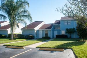 a house that has a lawn and some trees at Villas at Fortune Place in Kissimmee