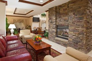 a living room with a stone fireplace at Holiday Inn Express Hotel & Suites Marion, an IHG Hotel in Marion