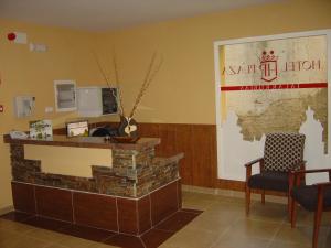 a lobby with a reception desk and a map on the wall at HOTEL PLAZA in Talarrubias
