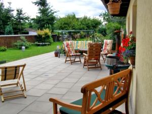 a patio with benches and a table and chairs at Ferienhaus Ursula in Malchow