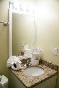 a white toilet sitting next to a sink in a bathroom at Villas at Fortune Place in Kissimmee