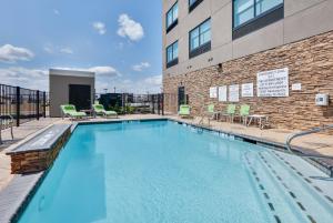 a swimming pool in front of a building at Holiday Inn Express & Suites Fort Worth North - Northlake, an IHG Hotel in Fort Worth