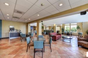 a waiting room with tables and chairs in a hospital at Holiday Inn Express Hotel & Suites Manteca by IHG in Manteca