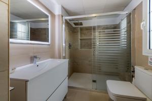 a bathroom with a sink and a shower at Villas Flamenco Beach Conil in Conil de la Frontera