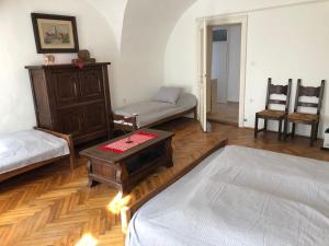 a living room with a bed and a table at Apartman Bécsi utca in Sopron