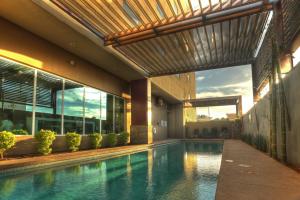 an indoor swimming pool in a house with a building at Holiday Inn Express & Suites Mexicali by IHG in Mexicali