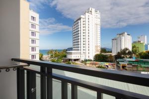 a balcony with a view of a city at XO Hotel & Apartments in Nha Trang