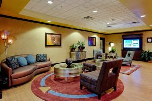 a lobby with a couch and a table and chairs at Holiday Inn Express Hotel and Suites - Odessa, an IHG Hotel in Odessa