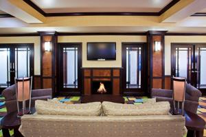 a living room with a fireplace and a tv at Holiday Inn Express Hotel & Suites Van Wert, an IHG Hotel in Van Wert