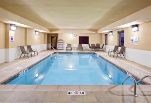a pool in a hotel room with chairs around it at Holiday Inn Express Hotel & Suites Van Wert, an IHG Hotel in Van Wert
