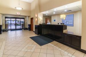 a hotel lobby with a woman sitting at a desk at Holiday Inn Express Hotel & Suites Vinita, an IHG Hotel in Vinita