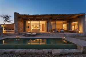 a house with a swimming pool in front of it at Six Senses Shaharut in Shaharut