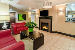 a living room with a couch and a fireplace at Holiday Inn Express Hotel & Suites Vinita, an IHG Hotel in Vinita