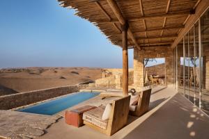 a house in the desert with a swimming pool at Six Senses Shaharut in Shaharut